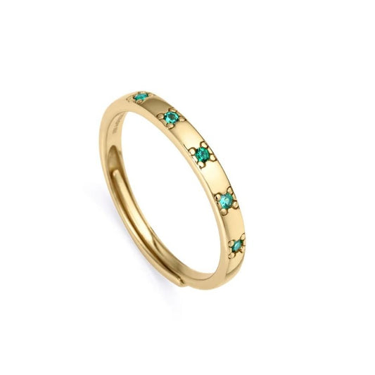 Gold band ring with small turquoise gems, slightly raised edges and simple design.