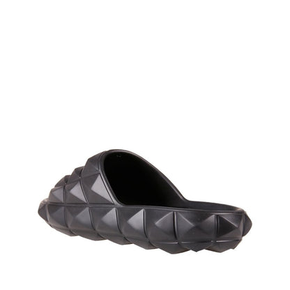 Valentino Garavani Black Rubber Slippers featuring all-over rubber studs, round open toe design, made in Italy for men.