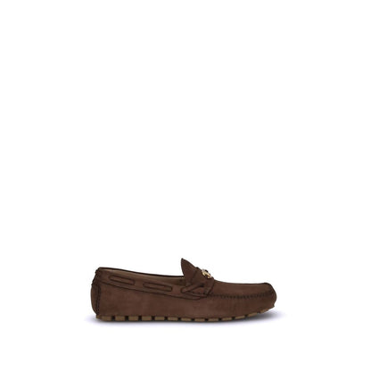 Valentino Garavani Brown Rubber Slip-On Loafers with VLogo plaque and notched sole for comfort and style.