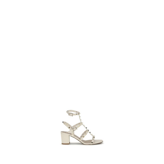 Valentino Garavani Cream Calf Leather Bos Taurus Sandals with Rockstud studs and adjustable ankle strap for a bold, elegant look.