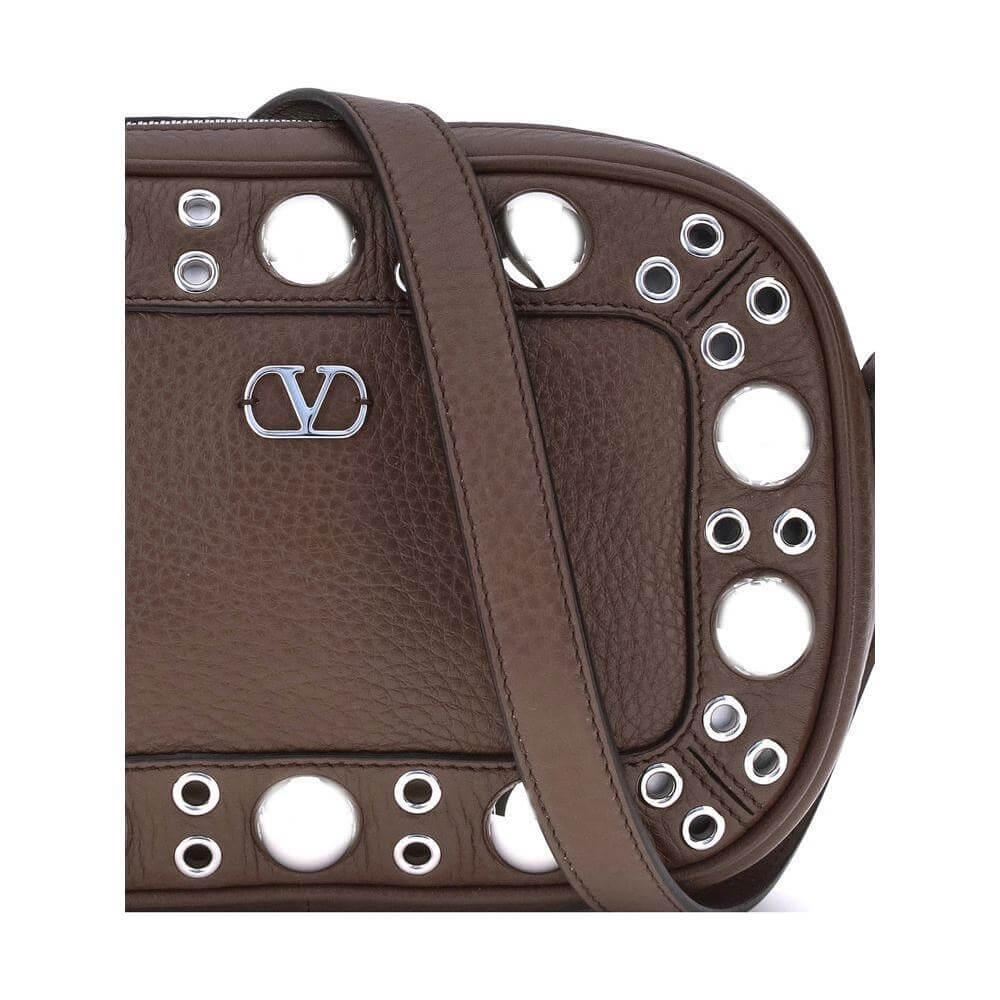 Valentino Garavani shoulder bag in garnet calfskin with metal logo, featuring rivets and ball studs for a stylish look.