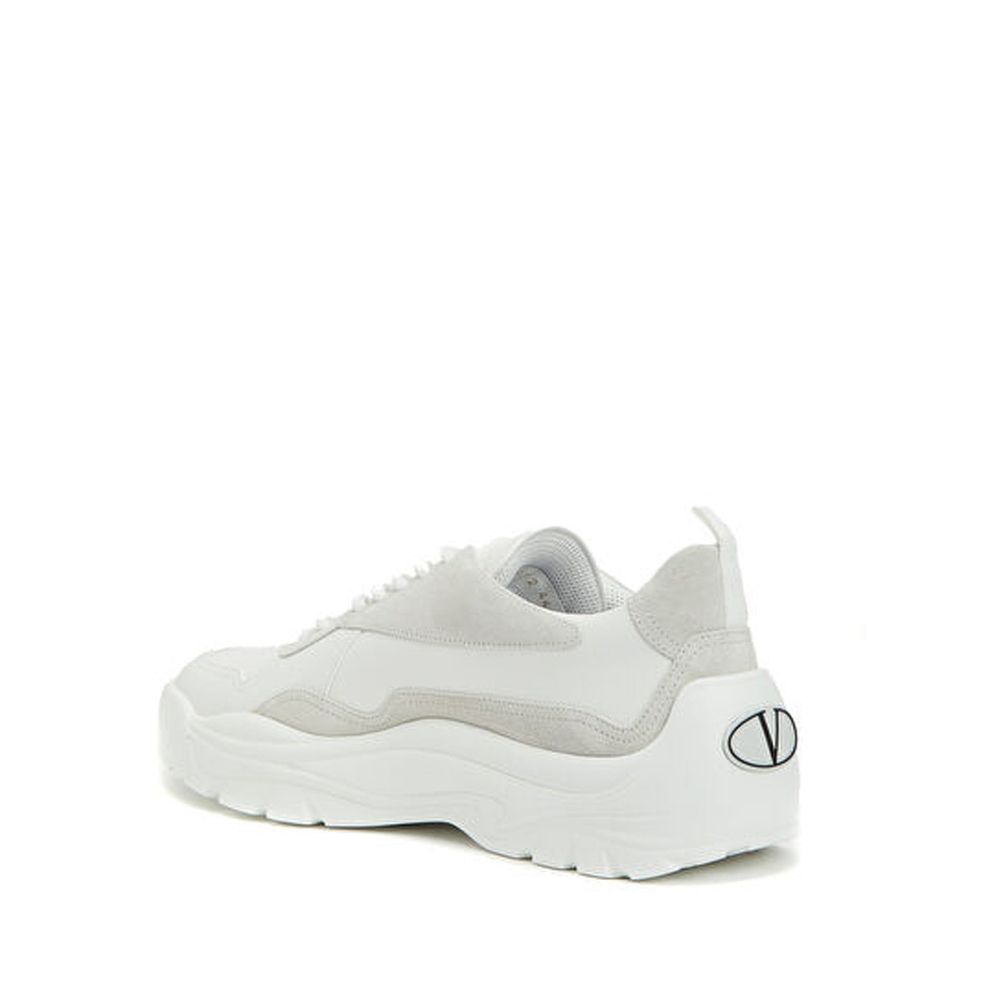 Valentino Garavani White Leather Low Top Sneakers with suede detail, contrast logo print, and rubber sole.